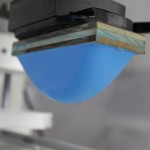 A blue object hanging from the ceiling of an industrial setting.