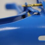 Blue metal clamp with brass adjustment screw
